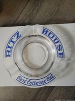 Top view of clear glass ashtray showing Ritz House and Port Colborne Ont. blue lettering