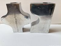 Front view of both interlocking zinc vases showing overall shape and finish