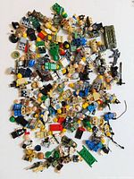 Full view of assorted Lego minifigures and accessories spread on surface