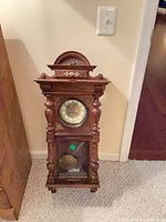 Shelf/parlor clock full view showing dial and pendulum