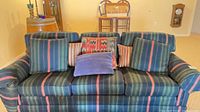 Front view of striped 3-seater sofa with pillows