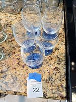 Five stemmed glasses viewed from above showing blue bases