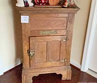 Front view showing door, brass latch, nameplate