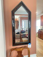 Full view of arched wall mirror hanging on wall