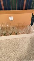 Box of mixed clear and green stem wine glasses