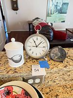 Clock, timer and ceramic canister grouped on countertop