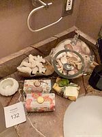 overall view of soaps, seashell jar, coral, candle