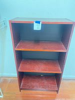Front view showing three shelves and finish