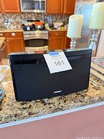 Front view of black Bose speaker on countertop