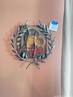 Full view of icon with laurel wreath frame on wall