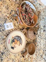All items together: Goebel plate, brown stoneware bowl with cloth, two brown handled crocks