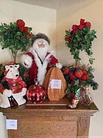 Full lot overview showing Santa, polar bear jar, two topiary trees, ornaments, pumpkin/gourd, wood board