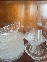 Group view of stacked plates, oval bowl and footed compote