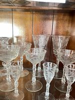 Group of mixed stemware showing floral etching and twisted stems