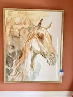 Full view of framed horse print on wall