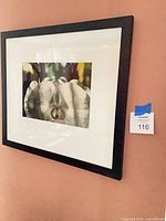 Framed orchid print on wall showing full frame and mat
