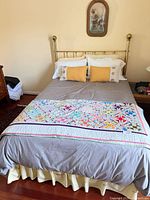 Full brass bed with bedding and quilt