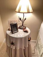 Entire lot showing table, lamp, frame, dish, plaque