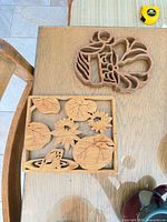 Two carved wooden trivets, frog/lily pad and turkey designs