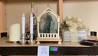 Full lot view on shelf showing terrarium, candles, gift box, decorated bottle