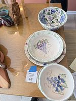 Stacked bowls and plate showing grape design