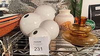 Four white glass globes, amber glass vase, ceramic vase on wire shelf
