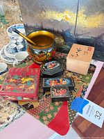Group shot of painting, lacquer boxes, Khokhloma bowl and spoon, Japanese box