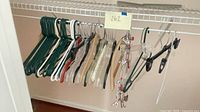 Full group of assorted hangers on wire shelf