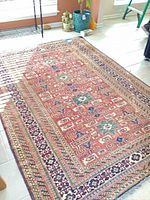 Full view of rug showing size, pattern, colors and fringe