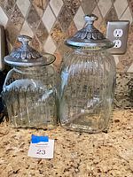 Both ribbed glass canisters side by side on countertop