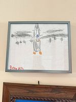 Grey metal frame containing child airplane drawing