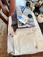 Stack of assorted linens showing various colors and textures