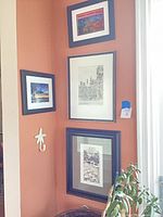 Wall view of all four framed prints showing relative sizes and subjects