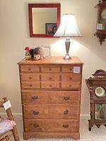 Front view of dresser with mirror, lamp, plush toy