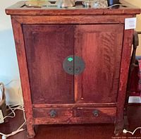 Front view of closed cabinet highlighting finish, hardware, drawers, and overall design