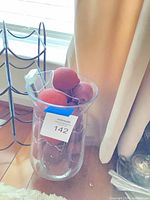 Vase filled with artificial peaches and string lights