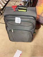 Front view showing overall suitcase, front pockets and size