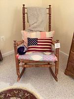 Front view of rocking chair with cushions and pillows