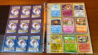 Binder open showing nine Pokémon card backs and nine face-up cards including Pikachu and Kabutops
