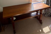 Full view of Mission oak trestle library table showing top, legs, stretcher shelf.