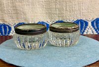 Pair of cut glass salt cellars on felt pad