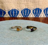 Both rings side by side showing stones and band design
