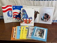 Group shot of all souvenir stamp folders front and back rows