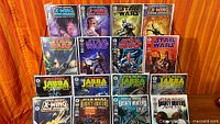 Front view showing 16 bagged and boarded Star Wars comics on display rack