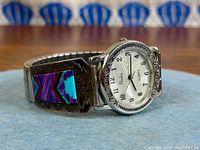 Full view of watch showing dial, sterling tips with inlay, and expansion band