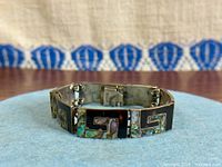 Front view showing abalone inlay Greek key design