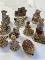 All twelve porcelain figurines arranged on countertop