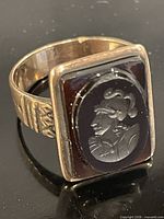 Angled view of ring showing cameo face and bezel