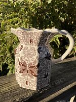 Front view of Mason's Bow Bells transferware water jug showing hexagonal body and pattern