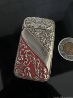 front view showing ornate design, size reference with 2012 Canadian coin